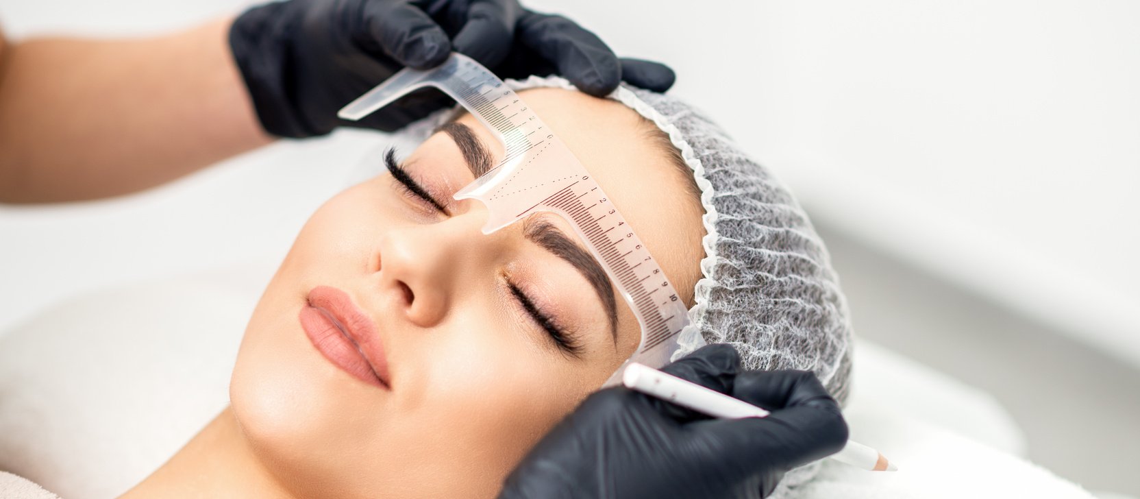 Beautician Measuring Brows with Ruler